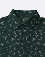 A dark green button-down shirt with an all-over white line-art pattern of ducks, shown on a light gray background.