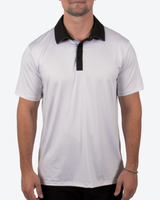 A man wearing a white short-sleeve polo shirt with a black collar and black placket, shown from the chin down against a light gray background.